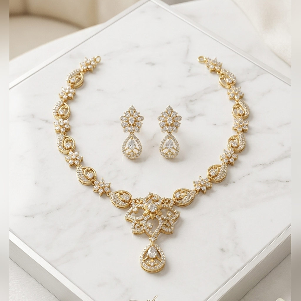 Gold CZ floral paisley necklace set with pear drop earrings on marble - PJ Fashion Pakistan